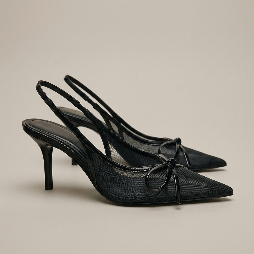 Close-up of Black Mesh Pointed Toe Slingback Heels with Bow
