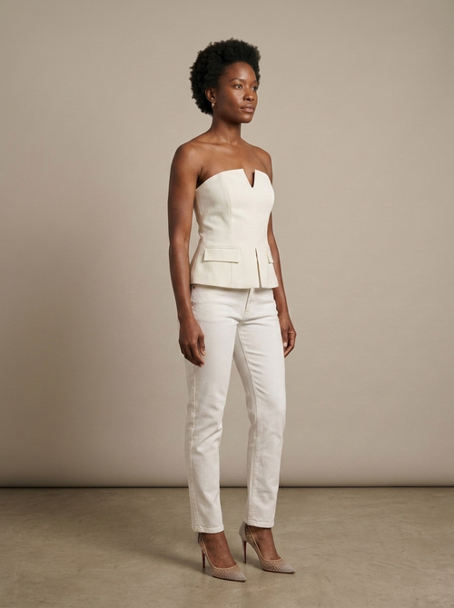 Cream Strapless Structured Peplum Top worn by a model, three-quarter angle