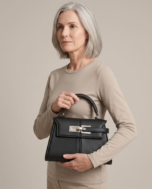 Top Handle Bag Structured Grained Leather Black worn by a model, close waist-up view